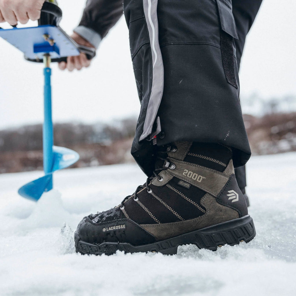 LaCrosse Cold Snap II 2000G boot worn in snow beside an ice auger