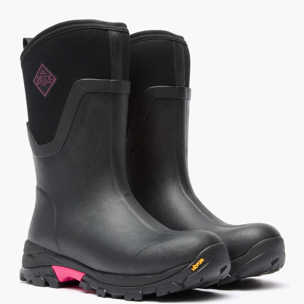Pair of Muck women's Arctic Ice Mid boots in Black/Pink, front three-quarter view
