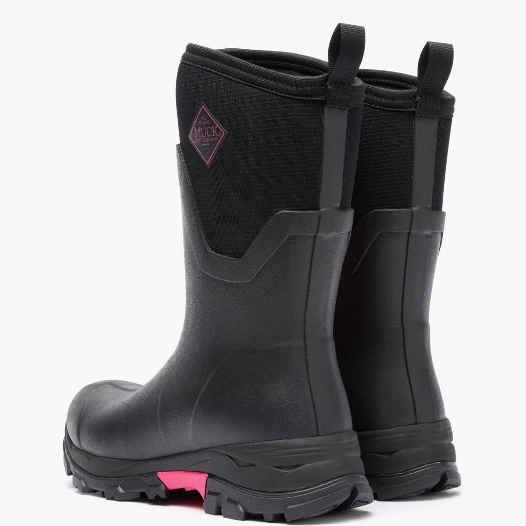 Pair of Muck women's Arctic Ice Mid boots in Black/Pink, rear view showing pull loops and heels