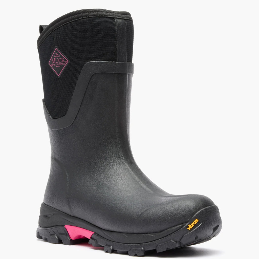 Muck women's Arctic Ice Mid boot in Black/Pink, angled front view showing Vibram outsole